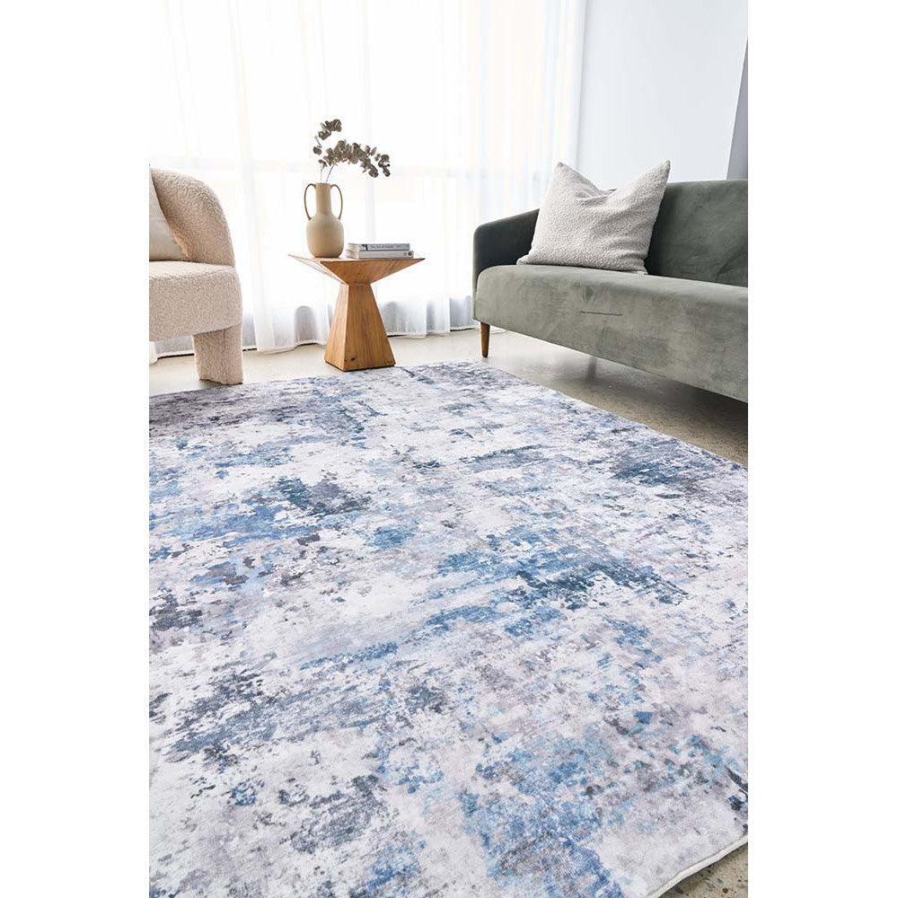 Revive Cato Blue Rug featuring abstract distressed pattern in blue, navy, grey and cream on ivory background, hand-tufted wool