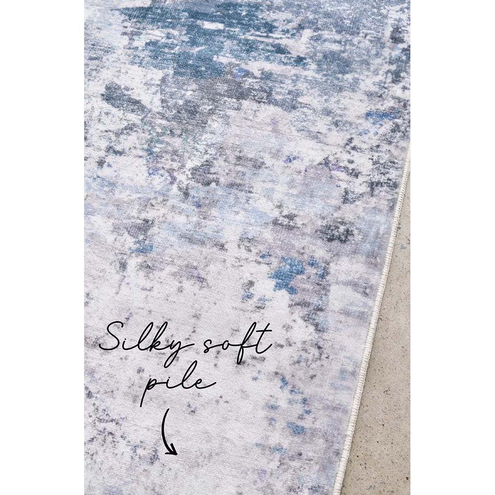 Revive Cato Blue Rug featuring abstract wash pattern in navy, powder blue, grey and ivory on light grey, machine-made polypropylene
