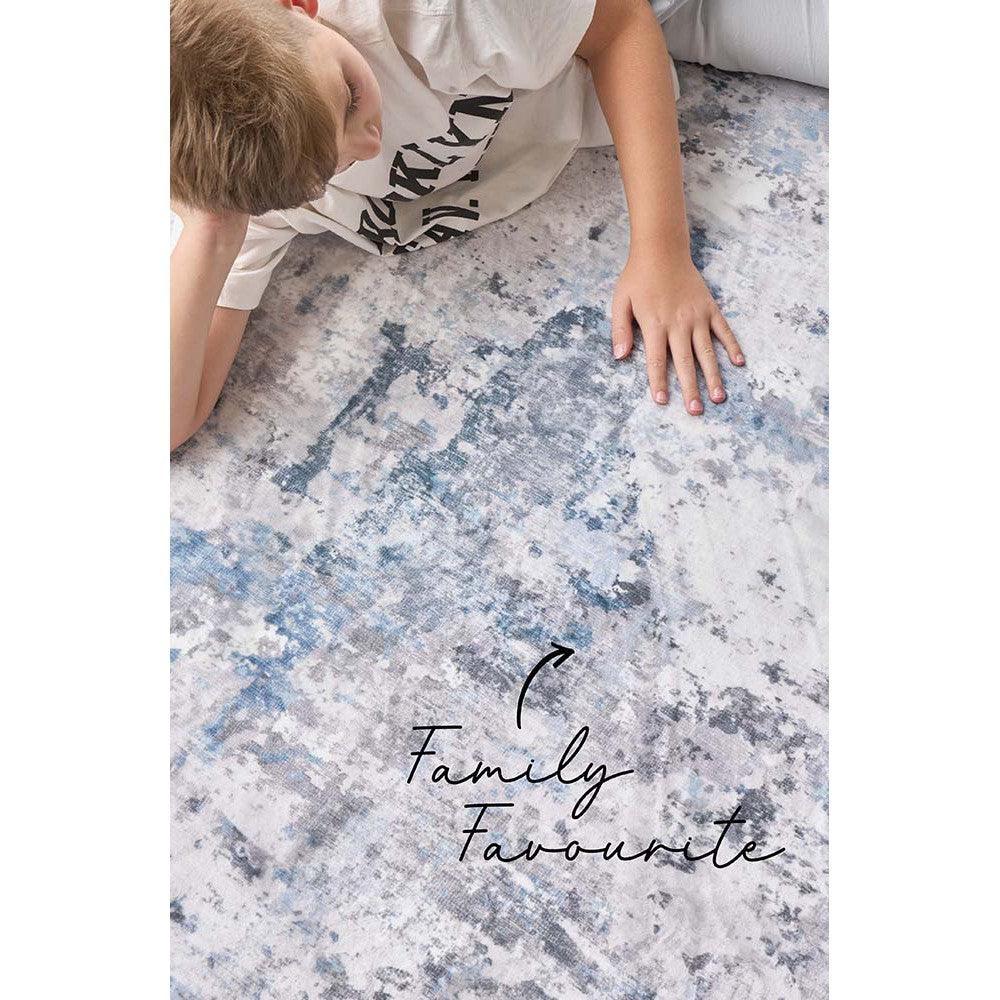 Revive Cato Blue Rug featuring abstract mottled pattern in blue, navy, grey on cream background, hand-tufted wool