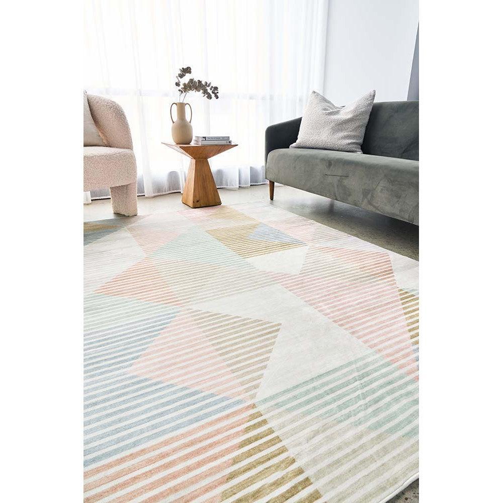 Revive Dali Pastel Rug featuring geometric triangles in peach, blush, blue and mint on ivory, hand-tufted wool