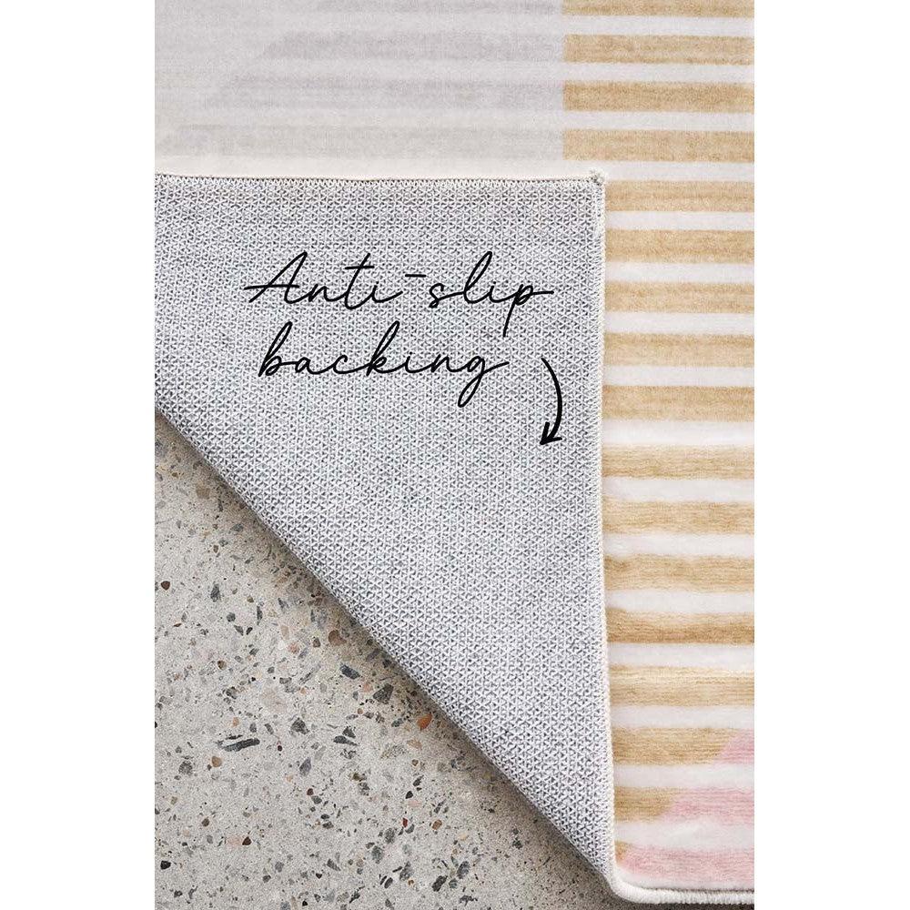 Revive Dali Pastel Rug featuring striped pastel pattern in blush pink, peach, cream and grey on pale pink background, power-loomed polypropylene