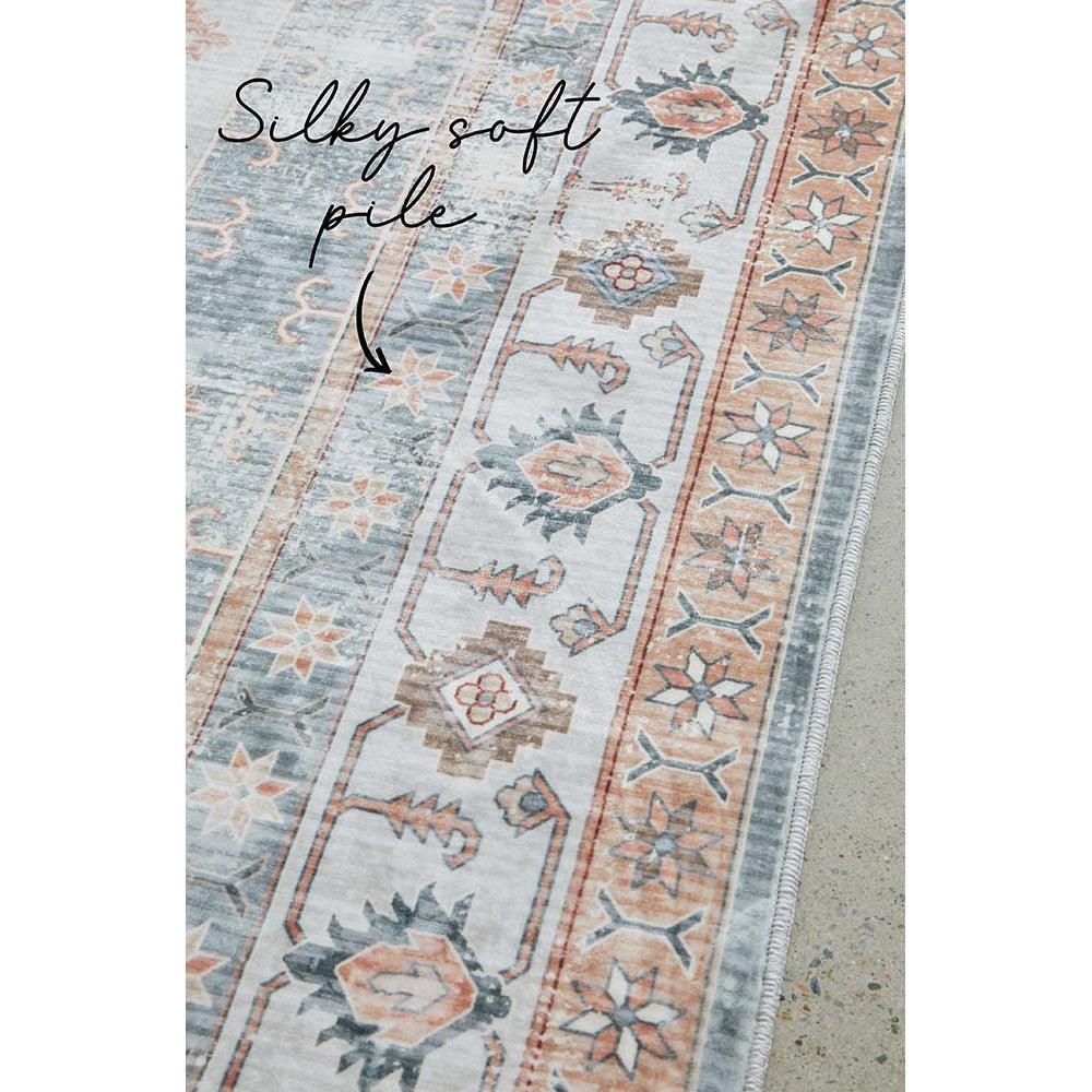 Revive Dawn Putty Rug featuring traditional border floral motif in pastel blue, peach, ivory on putty background.