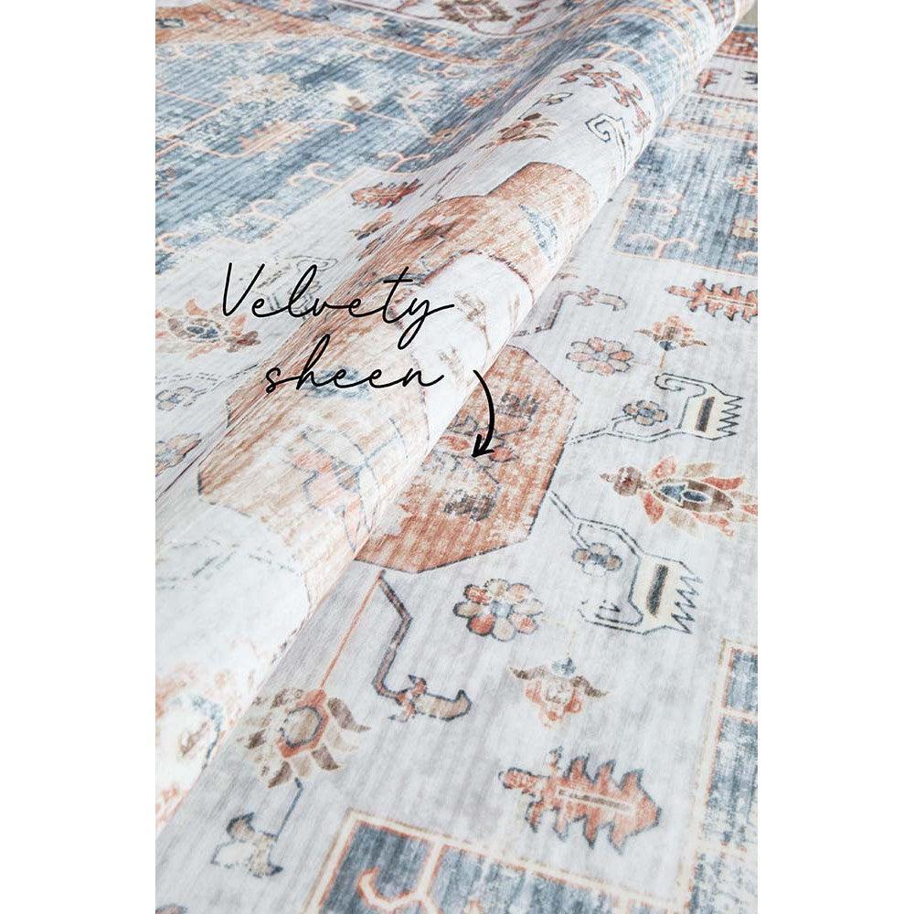 Revive Dawn Putty Rug featuring vintage-inspired pattern in dusty blue, ivory, peach and rust on putty background, hand-tufted wool