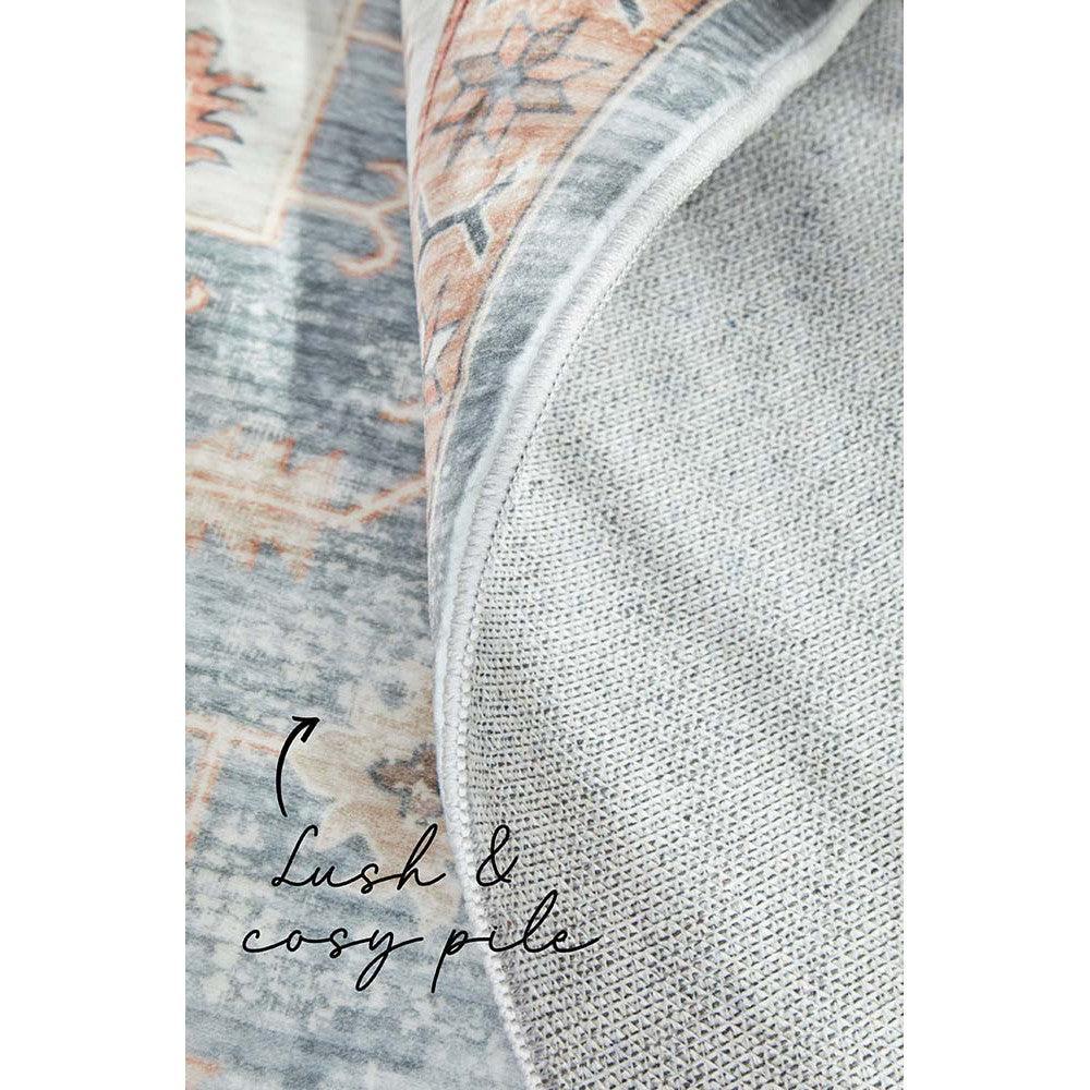 Revive Dawn Putty Rug featuring distressed vintage pattern in dusty rose, slate blue and ivory on soft grey, hand-tufted wool