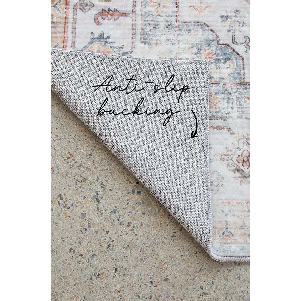 Revive Dawn Putty Rug featuring distressed vintage floral pattern in cream, dusty pink and sage blue on putty background with anti-slip backing, machine-woven