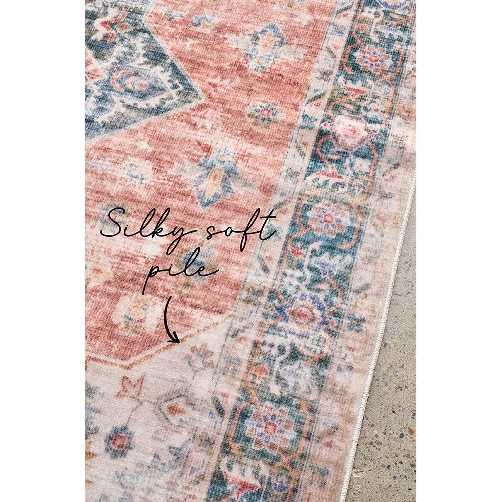Revive Lila Rust Rug featuring vintage floral pattern in dusty pink, navy blue, ivory on soft beige background, hand-tufted wool