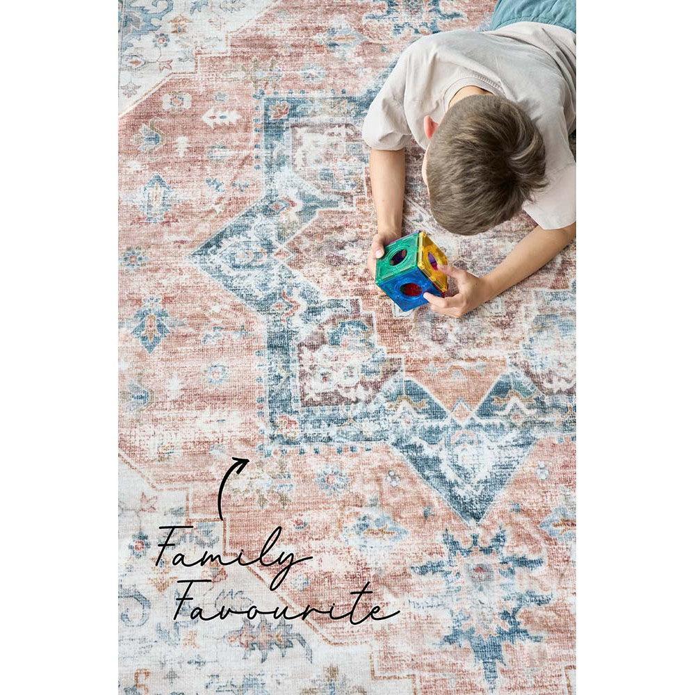 Revive Lila Rust Rug featuring distressed geometric pattern in rust, dusty pink, sky blue, teal on ivory background, hand-tufted wool