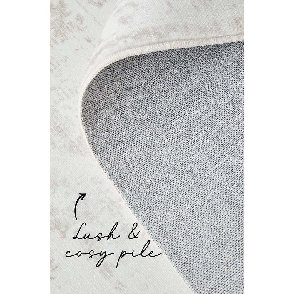 Revive Loni Natural Rug featuring solid plush pile in ivory with blue-gray underside on cream background, hand-tufted wool