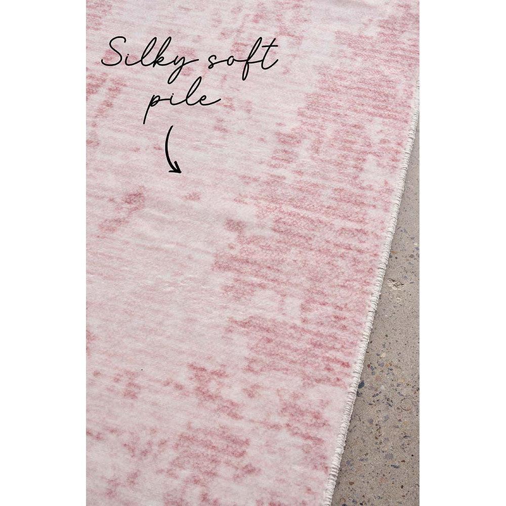 Revive Muse Blush Rug featuring silky soft pile in blush pink marbled pattern on light grey background, hand-tufted wool