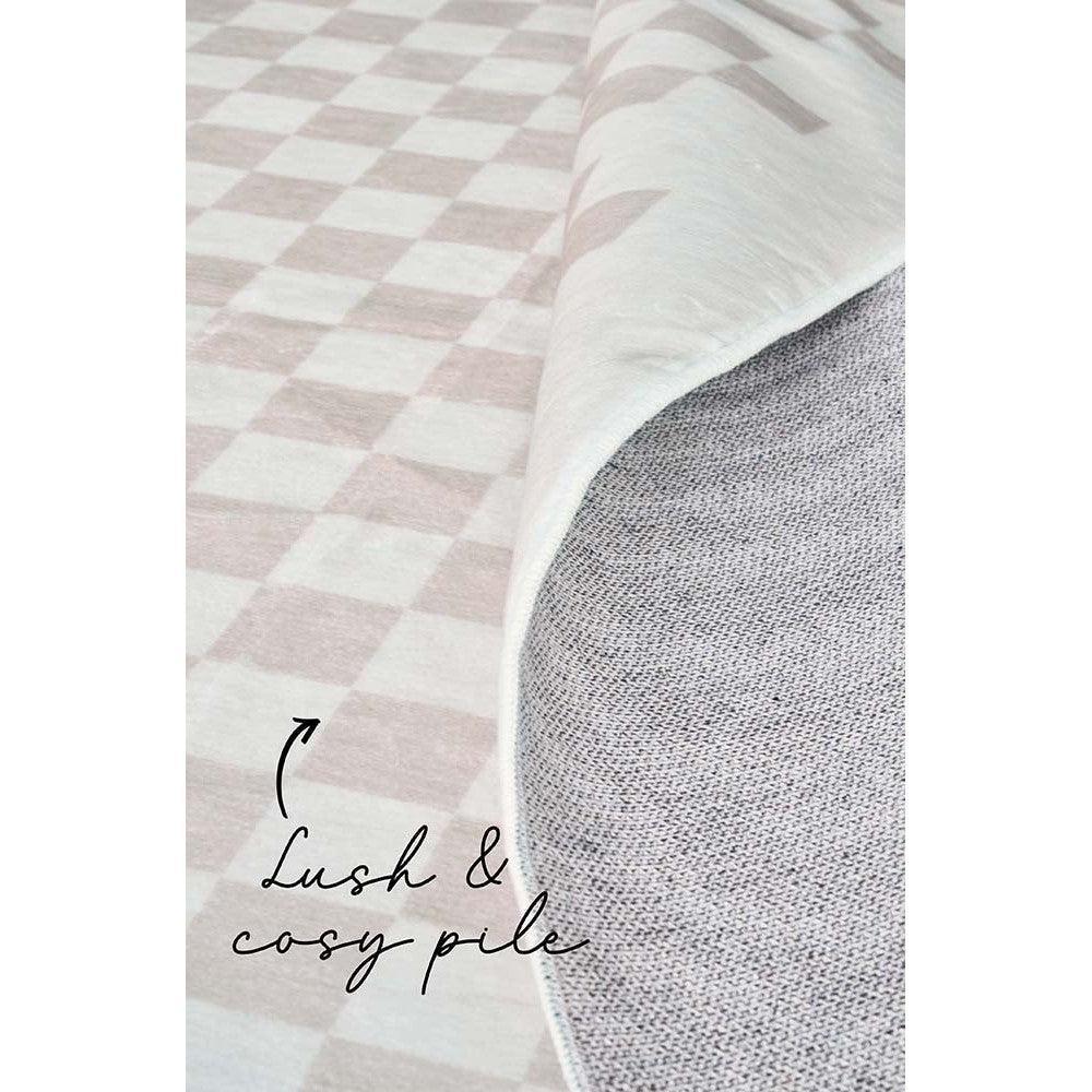 Revive Toshi Natural Rug featuring checkerboard pattern in blush pink, ivory and cream on pale background, woven textile