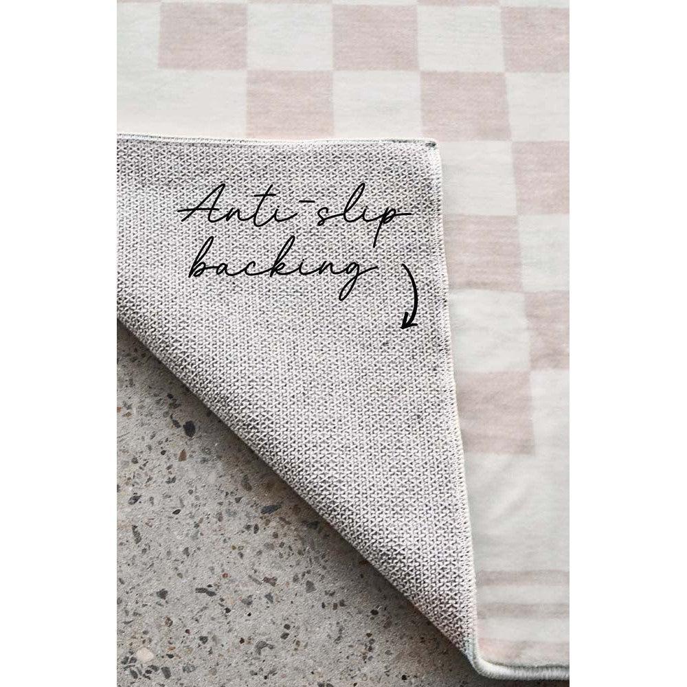 Revive Toshi Natural Rug featuring textured woven pattern in cream, beige and taupe on pale pink backdrop, machine-made wool