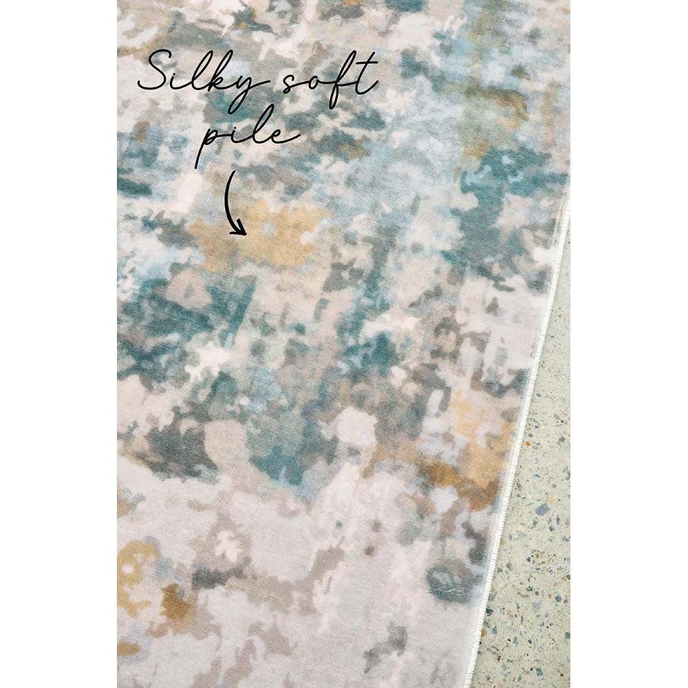 Revive Zane Marine Rug featuring abstract watercolor pattern in navy blue, teal, seafoam and sand on cream background, hand-tufted wool